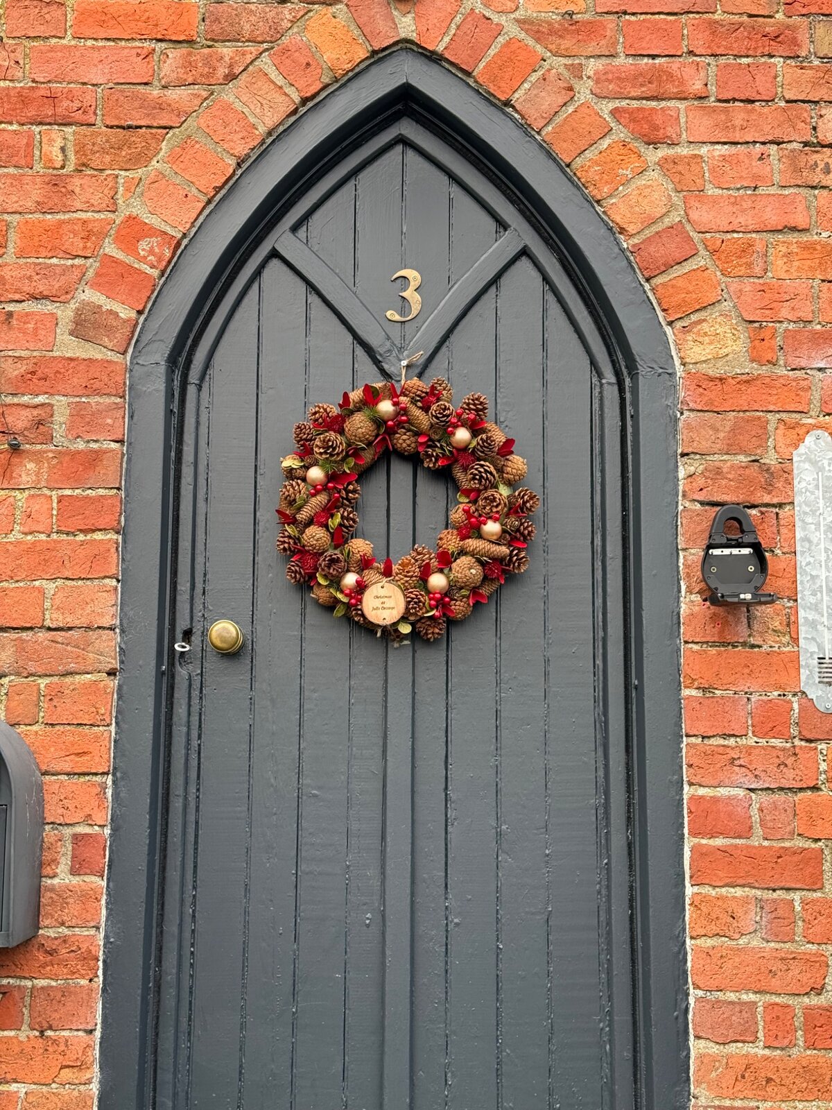 A Christmas wreath on the cottage's arched front door