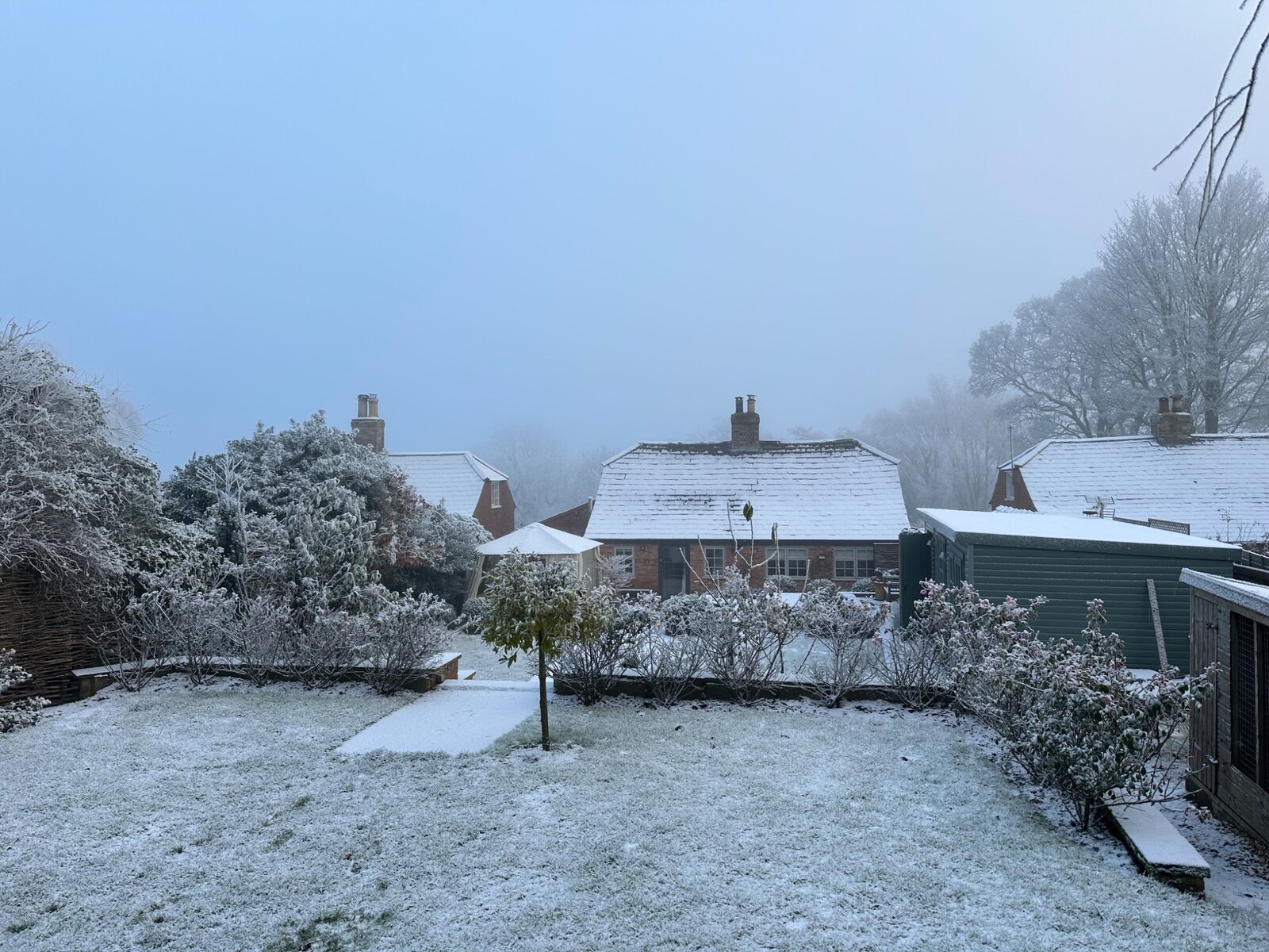 Snow over the garden and rooftops at Jolls Cottage